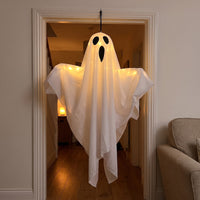 Bo the ghost light glowing in a home doorway in the evening