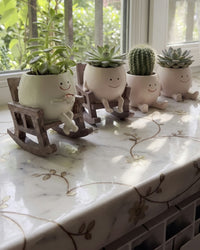 All four Melt Nook planters lined up on a marble windowsill