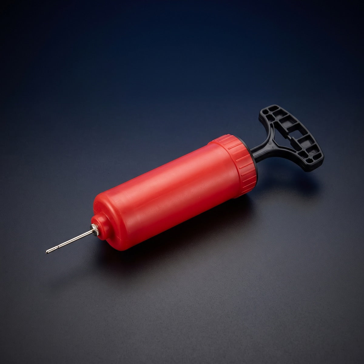Red hand ball pump with needle for inflating the Glow Ball