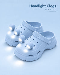 Sky blue platform clogs with four sky blue LED headlights glowing on the toes