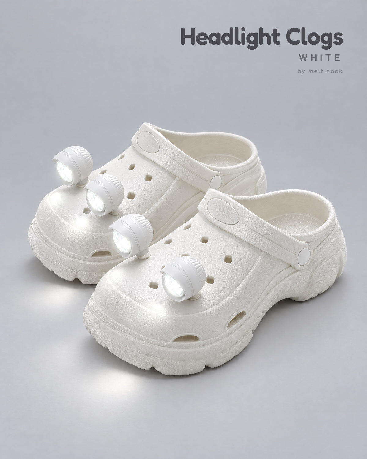 White platform clogs with four white LED headlights glowing on the toes