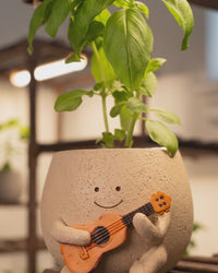 Close-up of Ollie holding his ukulele