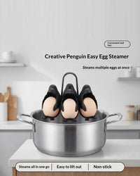 The penguin egg holder resting on the rim of a steel pot in a bright kitchen. Text on the image reads: Creative Penguin Easy Egg Steamer, steams multiple eggs at once, steams all in one go, easy to lift out, non-stick.