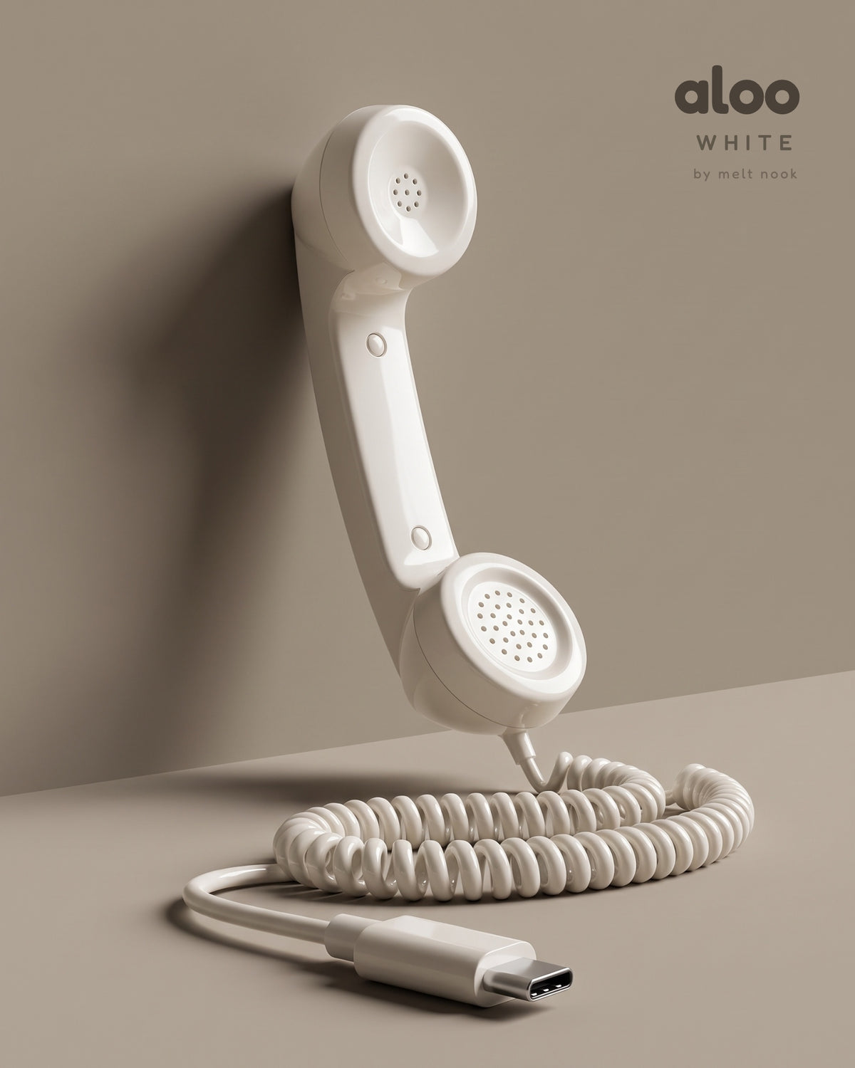 Aloo in white standing against a warm grey wall, its coiled USB-C cord on the floor